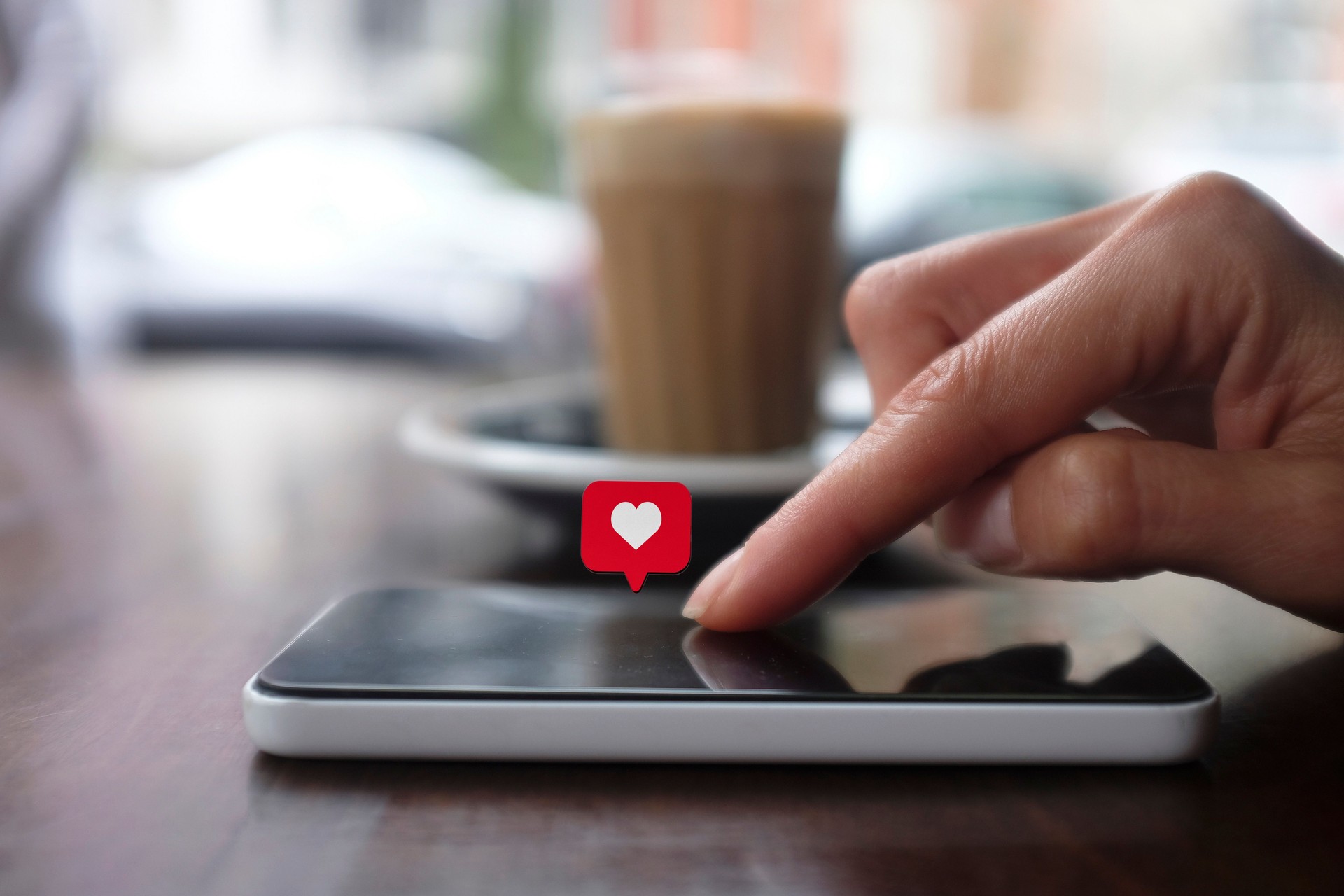 Young woman using smart phone with social media symbols